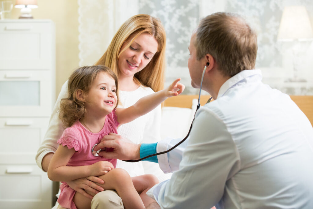 woman-holding-little-girl-while-doctor-listens-to-her-chest_gettyimages-612721732
